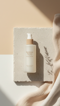 Radiance Renew Facial Cleanser, Three-quarter angle hero shots on softly textured stone or linen backgrounds in natural...